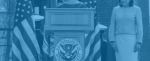 Person speaking at a podium with the Department of Homeland Security seal.